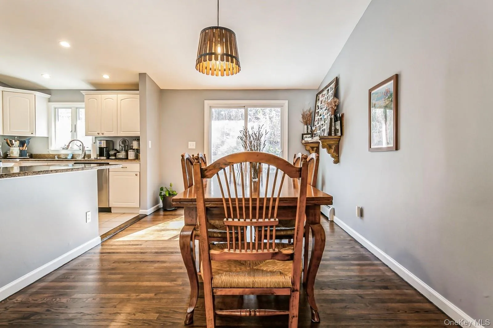 Dining room with baseboards, a chandelier, wood finished floors, and recessed lighting Dining room with baseboards, a chandelier, wood finished floors, and recessed lighting