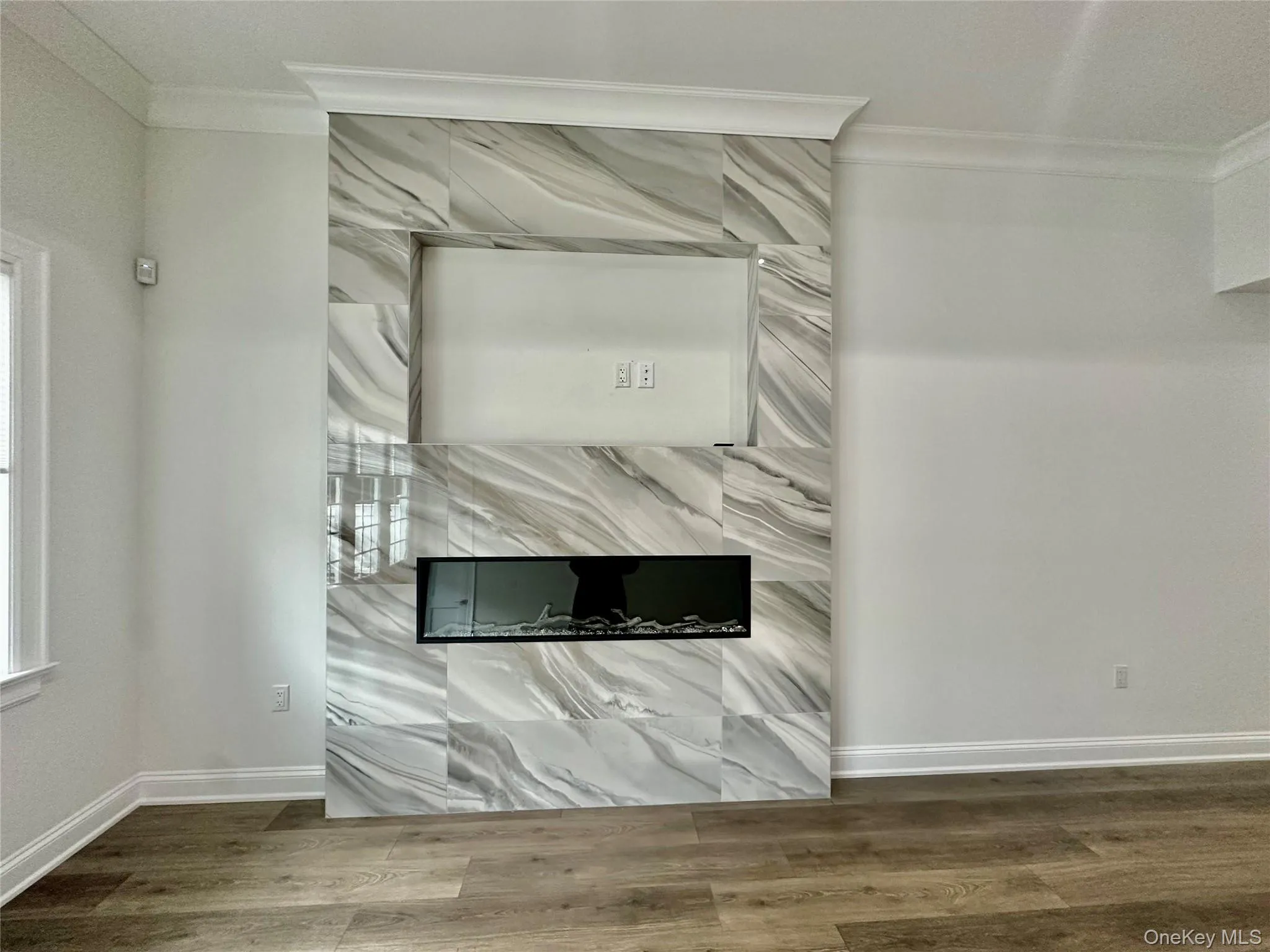 Detailed view of ornamental molding and wood finished floors Detailed view of ornamental molding and wood finished floors