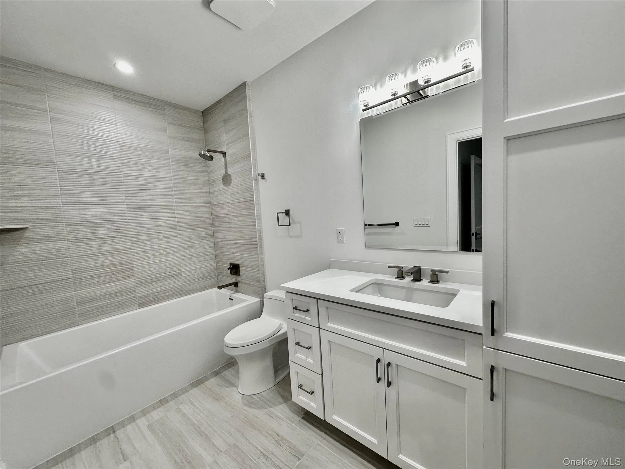 Full bath with shower / bath combination, vanity, and recessed lighting Full bath with shower / bath combination, vanity, and recessed lighting