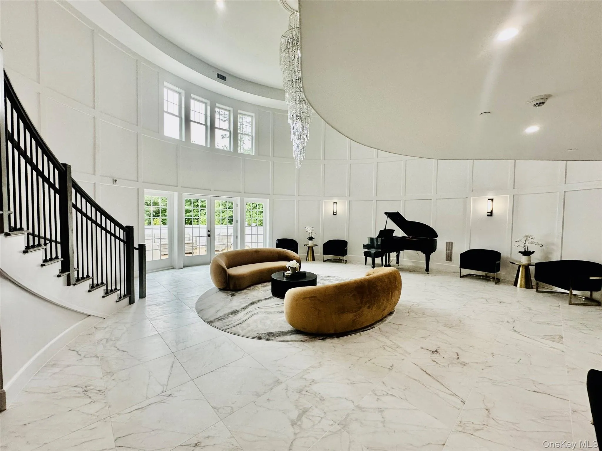 Building lobby featuring a decorative wall and a towering ceiling Building lobby featuring a decorative wall and a towering ceiling