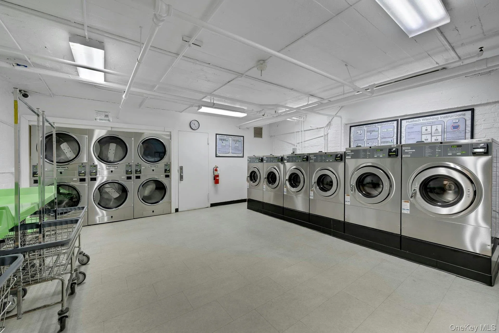 Shared laundry room with washing machine and dryer Shared laundry room with washing machine and dryer
