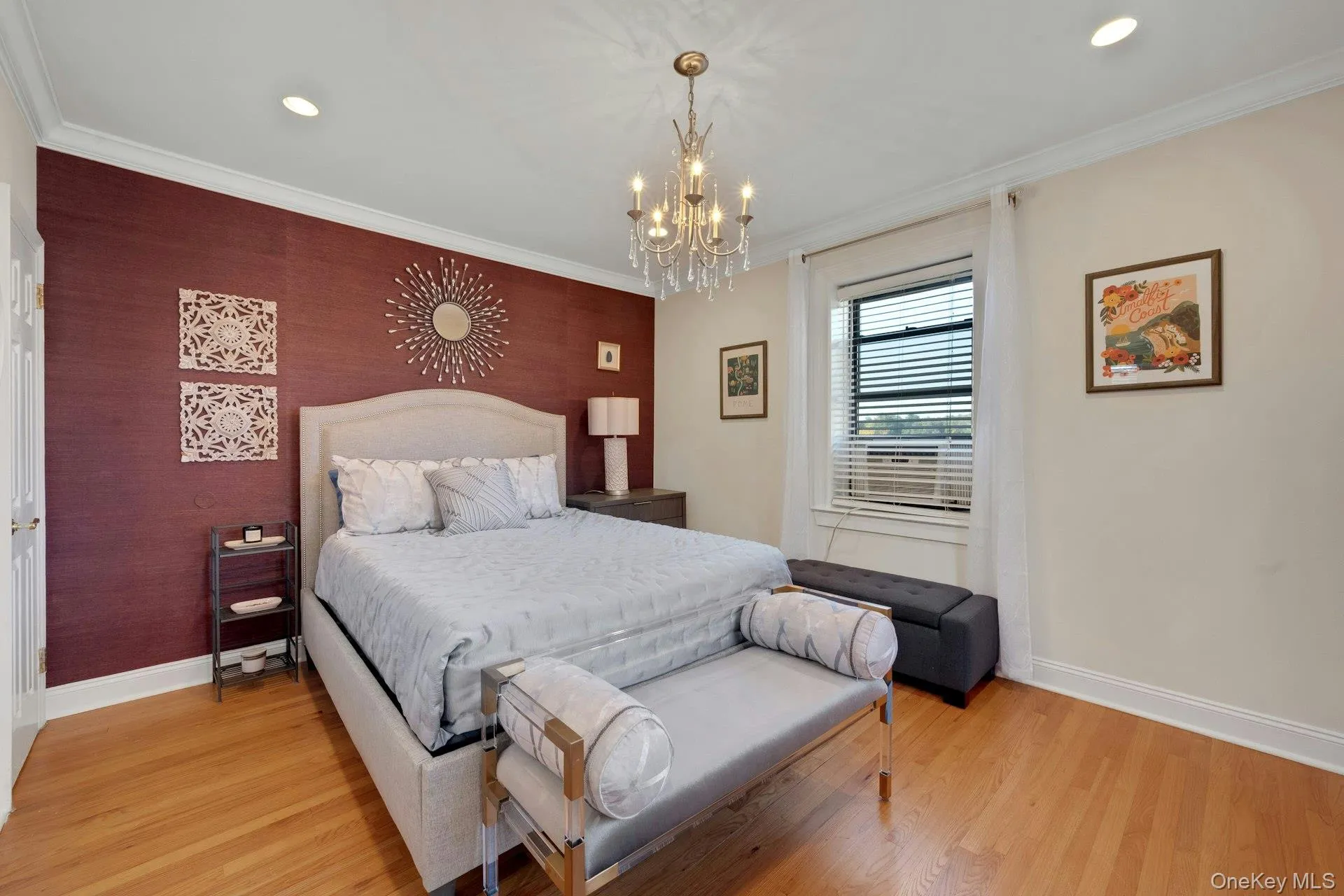 Bedroom with crown molding, light wood-style flooring, recessed lighting, a chandelier, and an accent wall Bedroom with crown molding, light wood-style flooring, recessed lighting, a chandelier, and an accent wall