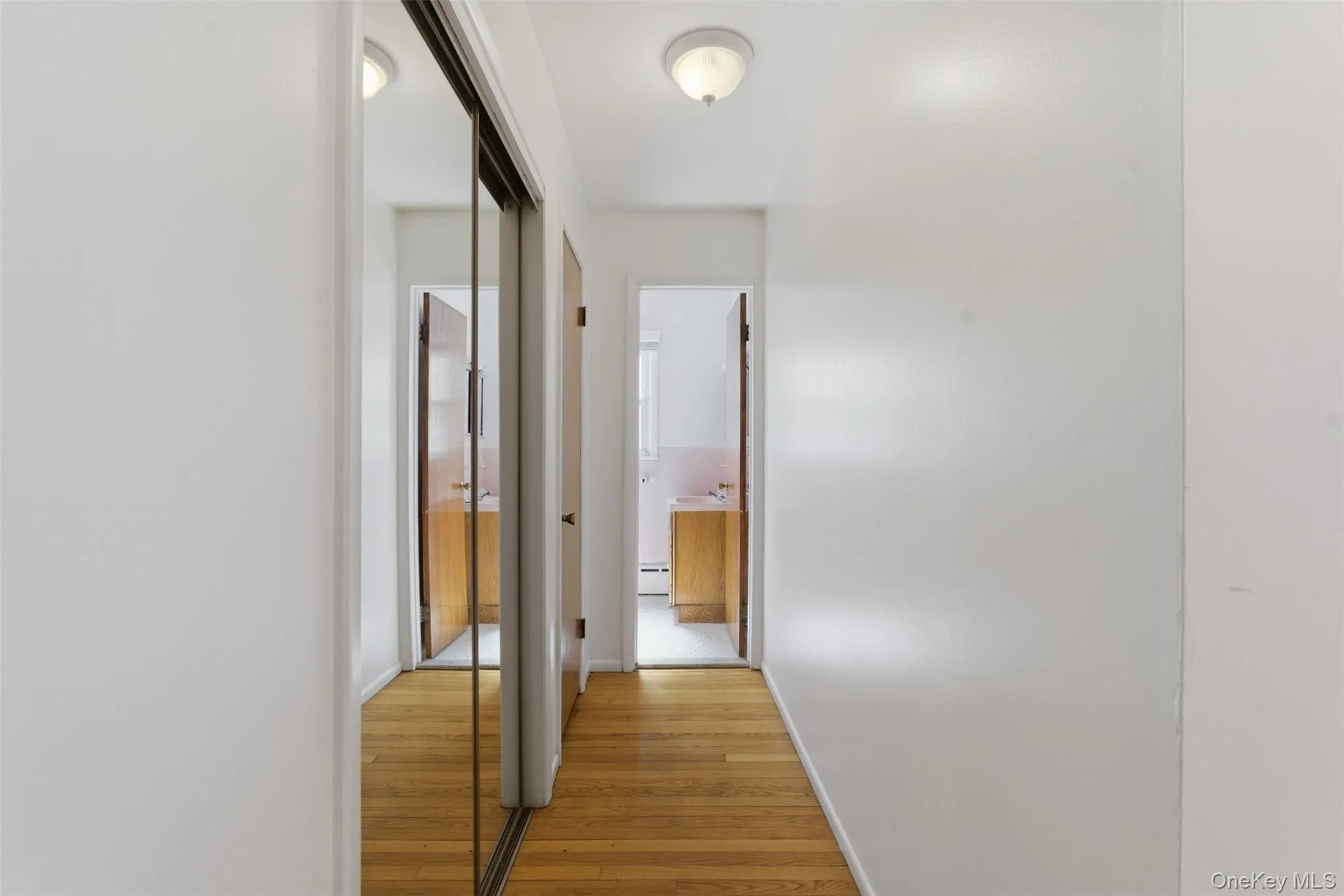 Hallway from bedroom to bathroom, with large walk in closet Hallway from bedroom to bathroom, with large walk in closet