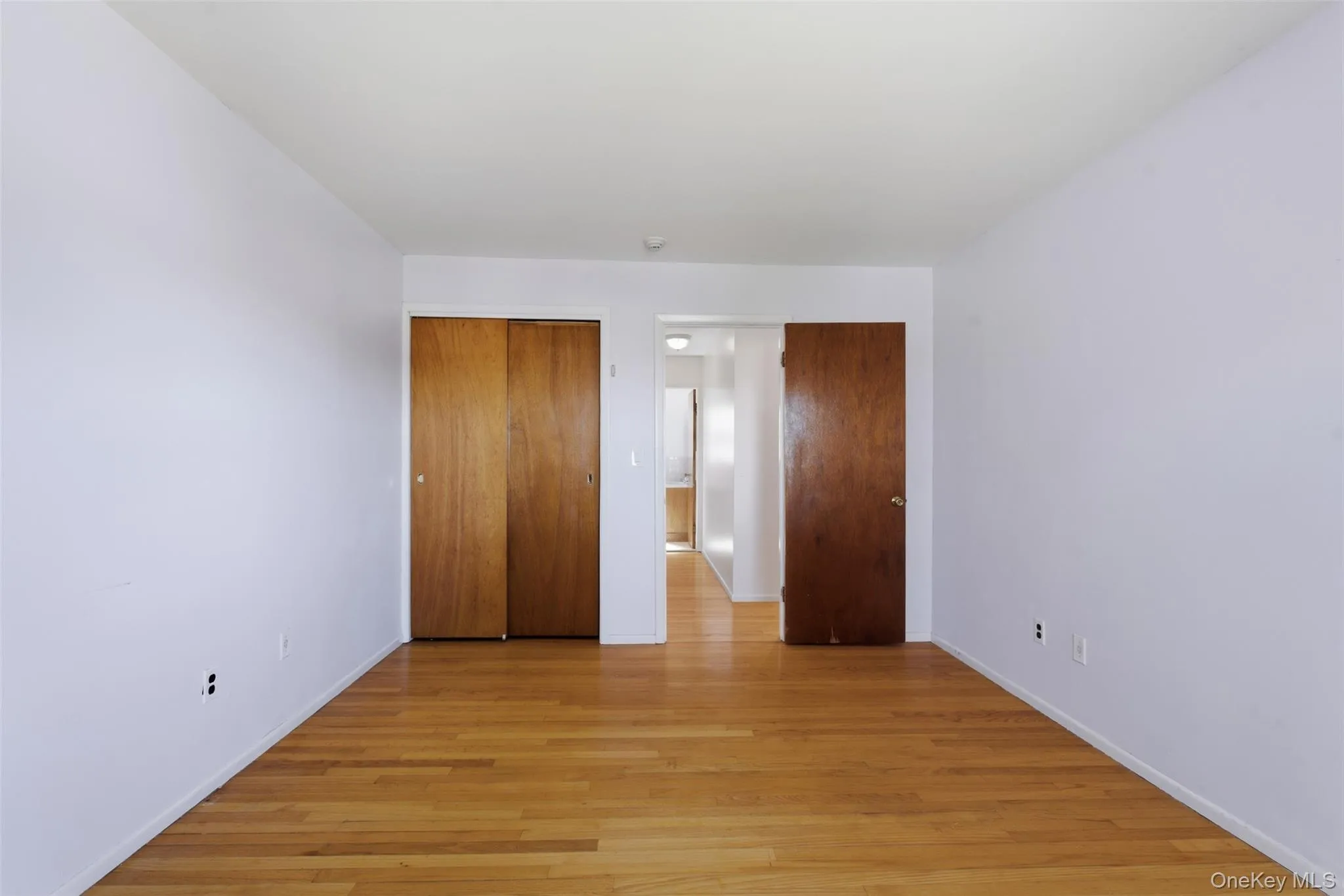 View of airy bedroom from the direction of the two windows, and closet. View of airy bedroom from the direction of the two windows, and closet.