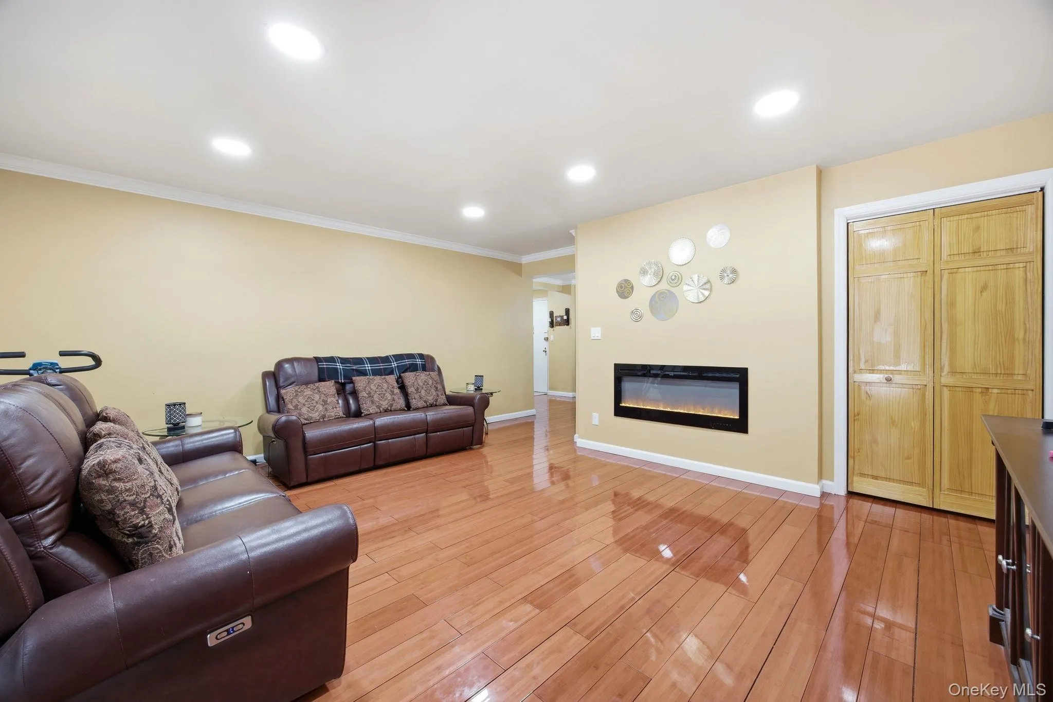 Living room angle featuring a glass covered remote control electric fireplace. Living room angle featuring a glass covered remote control electric fireplace.