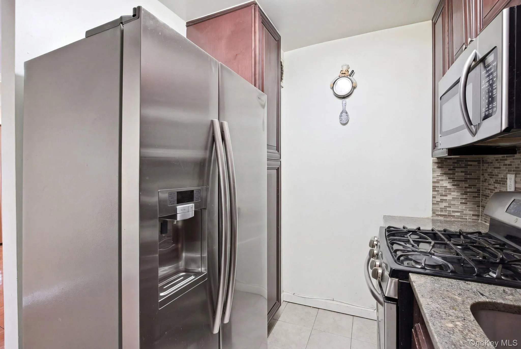Kitchen angle featuring the stainless steel appliances. Kitchen angle featuring the stainless steel appliances.