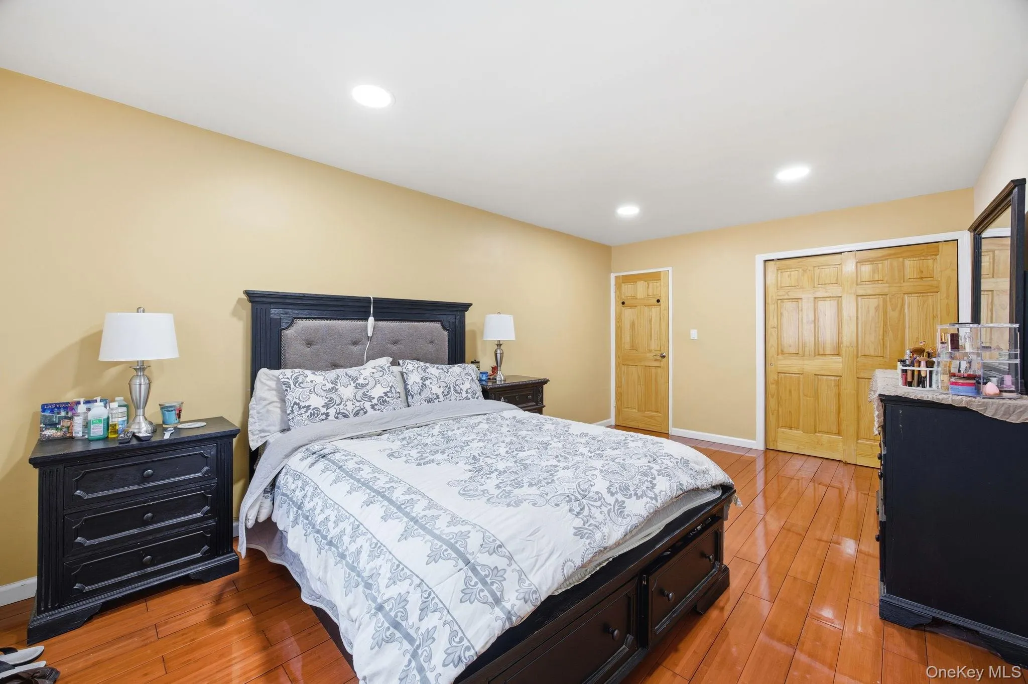 Bedroom featuring light wood-style floors, a closet, and recessed lighting. Bedroom featuring light wood-style floors, a closet, and recessed lighting.