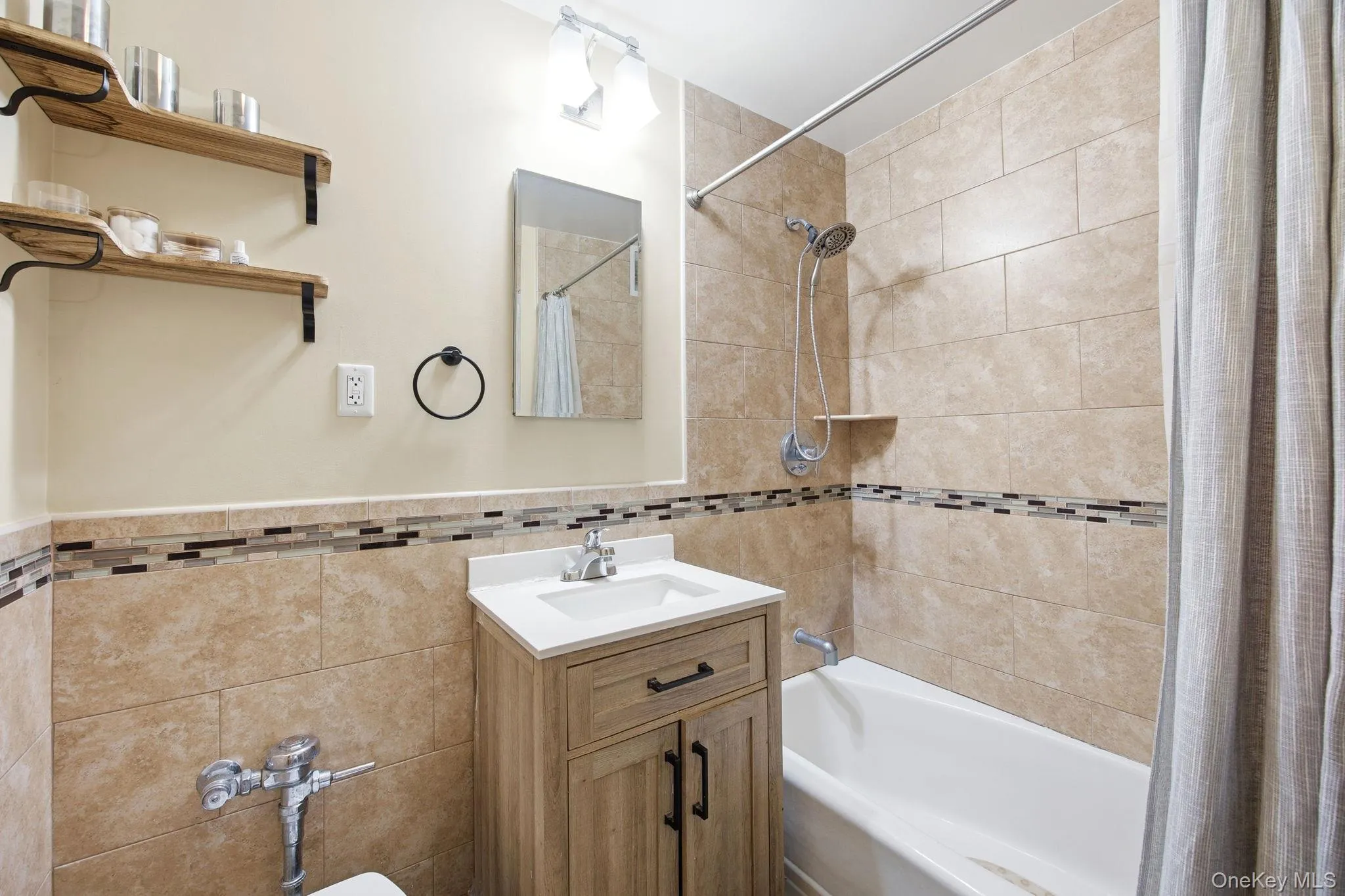 Full bathroom with vanity, shower / tub combo and beautifully tile walls. Full bathroom with vanity, shower / tub combo and beautifully tile walls.