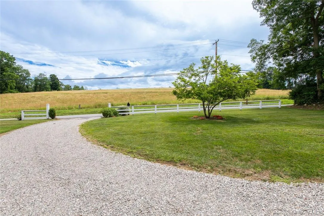 View of property's community featuring a rural view and a lawn View of property's community featuring a rural view and a lawn