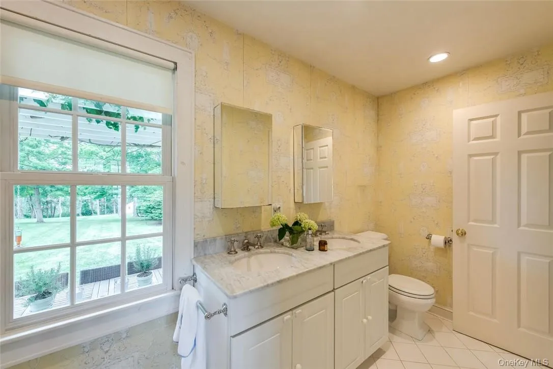 Bathroom with vanity, toilet, and tile patterned floors Bathroom with vanity, toilet, and tile patterned floors