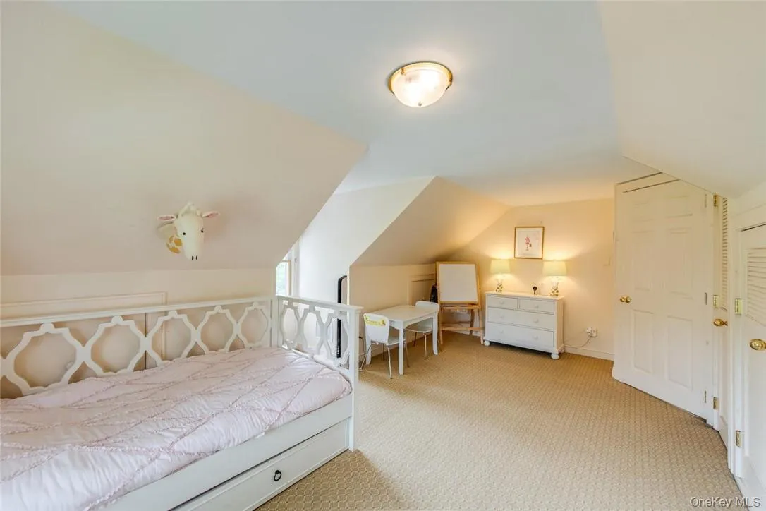 Bedroom featuring carpet flooring and vaulted ceiling Bedroom featuring carpet flooring and vaulted ceiling
