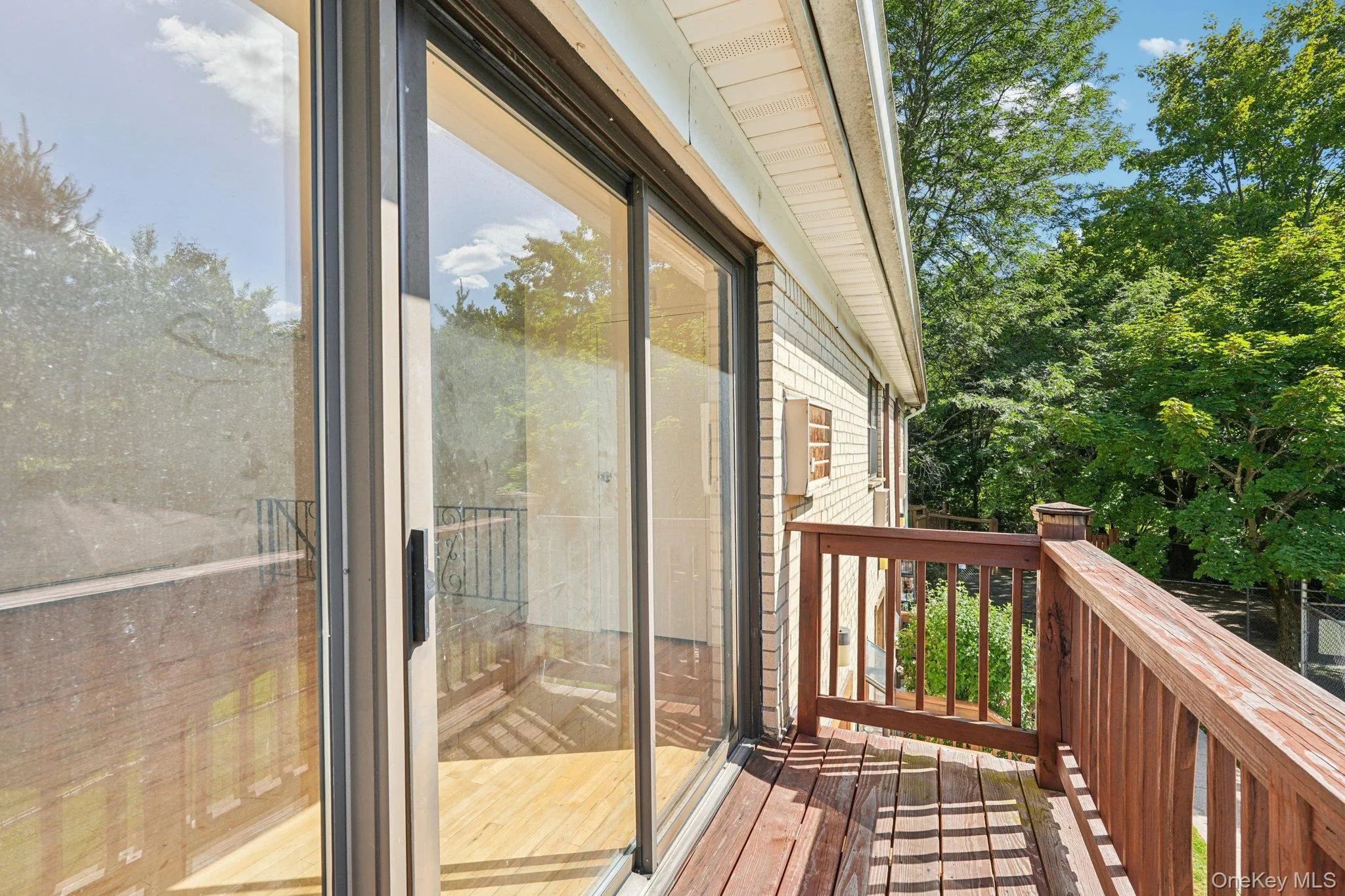 Wooden terrace featuring view of wooded area Wooden terrace featuring view of wooded area