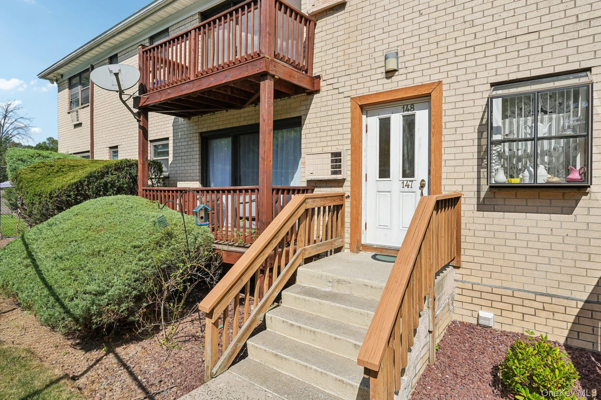 View of exterior entry with a wooden deck and brick siding View of exterior entry with a wooden deck and brick siding