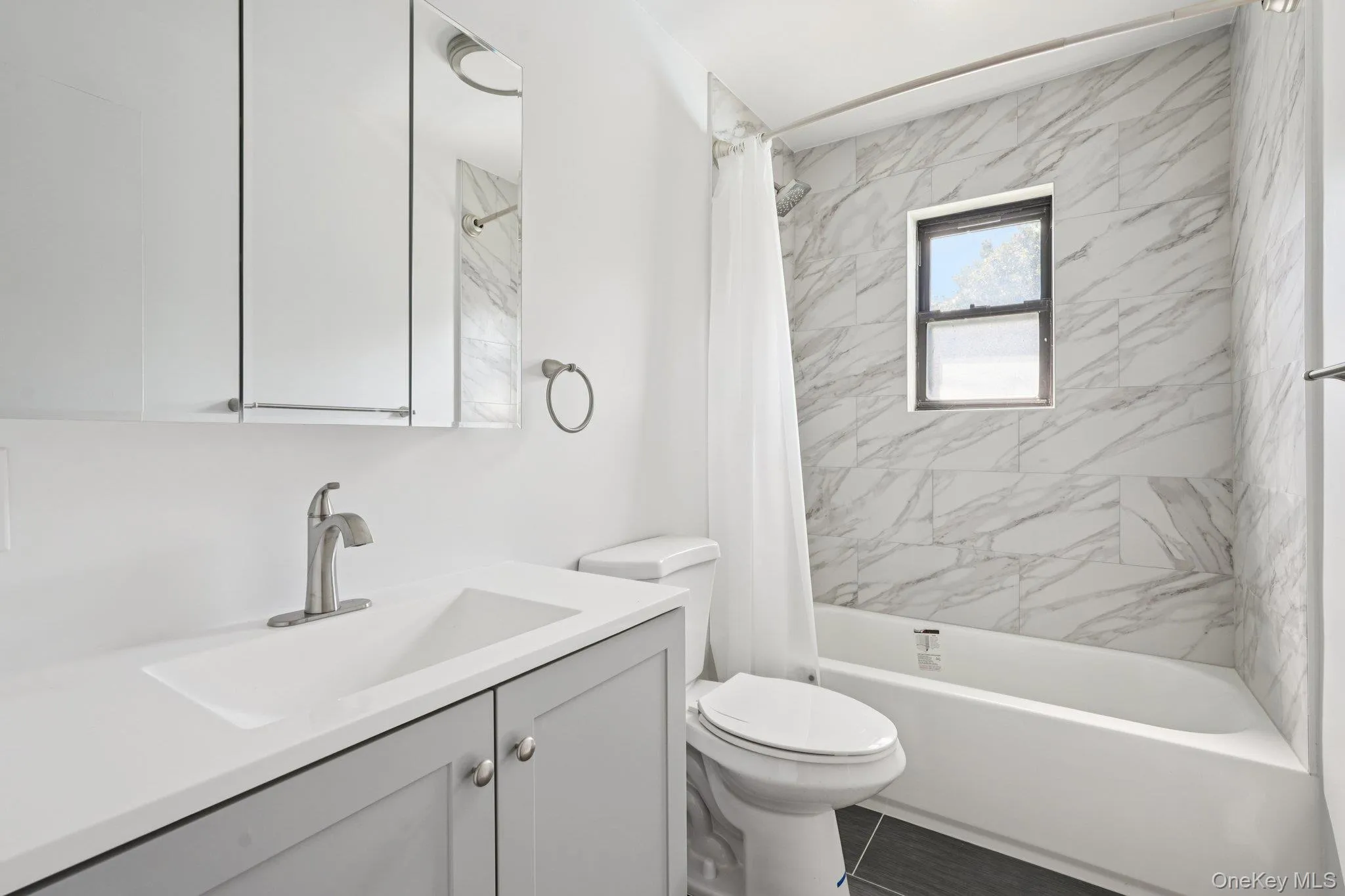 Full bathroom featuring shower / tub combo with curtain and vanity Full bathroom featuring shower / tub combo with curtain and vanity