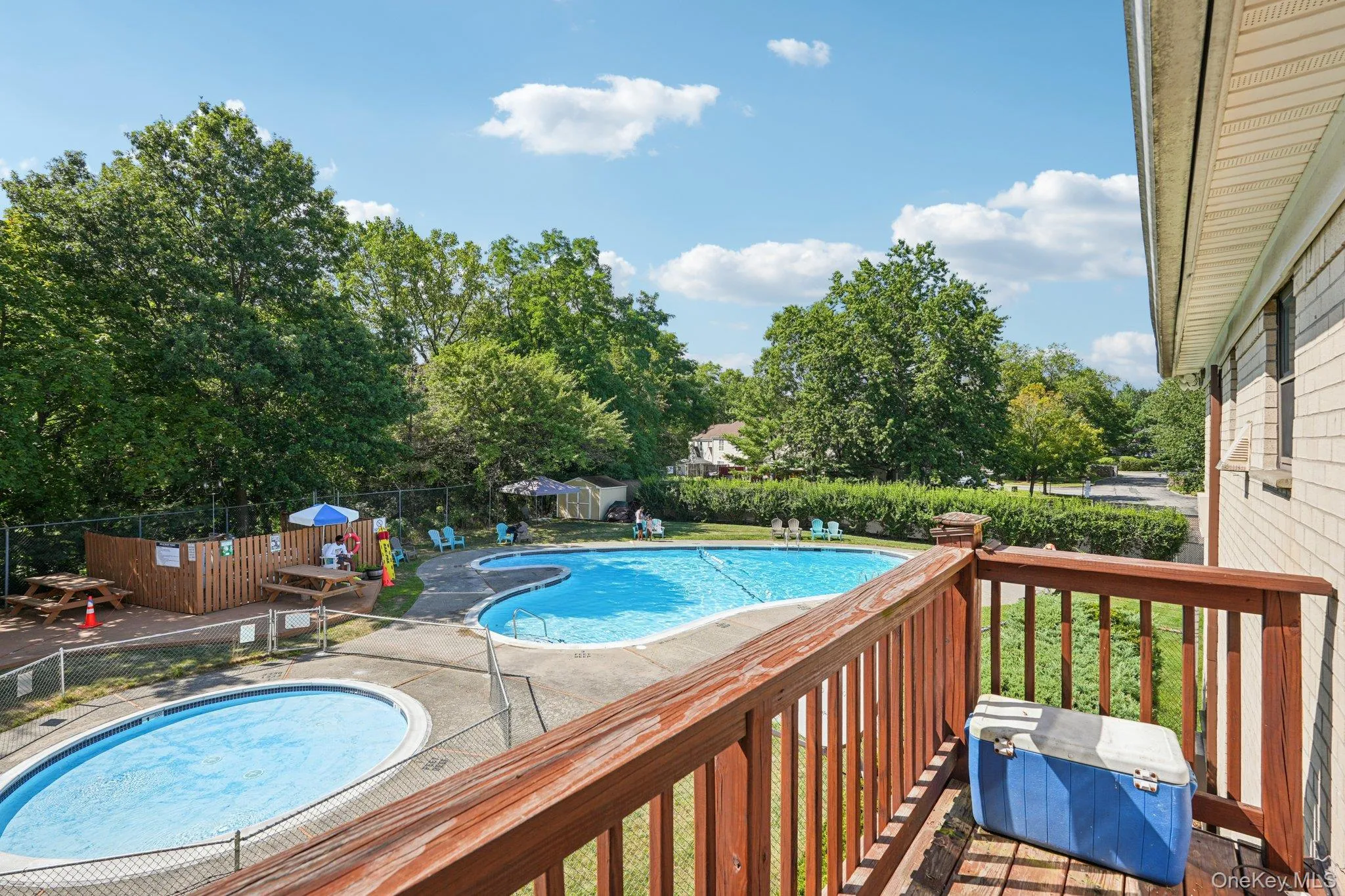 Community pool featuring a balcony, a community hot tub, and a patio Community pool featuring a balcony, a community hot tub, and a patio