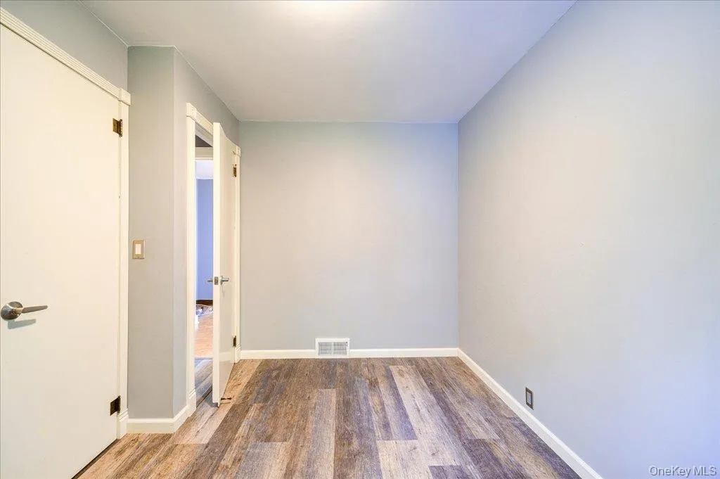 Bedroom room with dark hardwood / wood-style floors Bedroom room with dark hardwood / wood-style floors