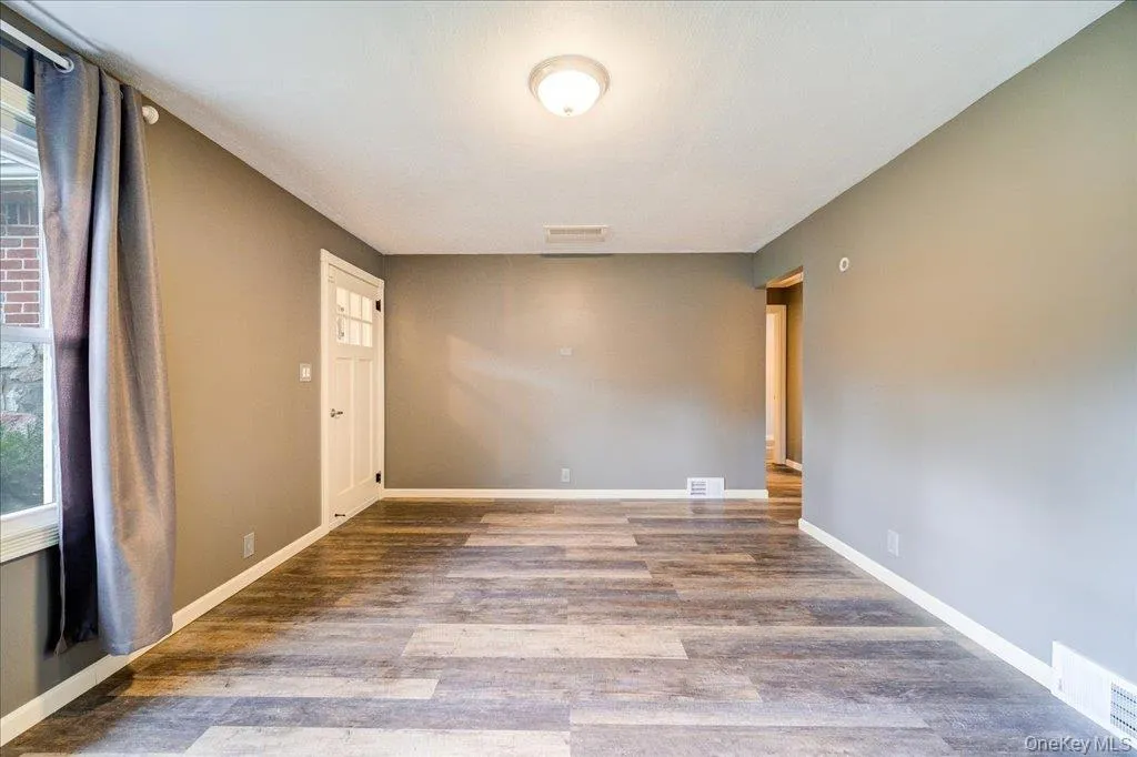 Empty room with hardwood / wood-style floors Empty room with hardwood / wood-style floors