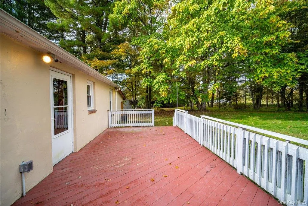 Wooden deck featuring a large, level yard Wooden deck featuring a large, level yard