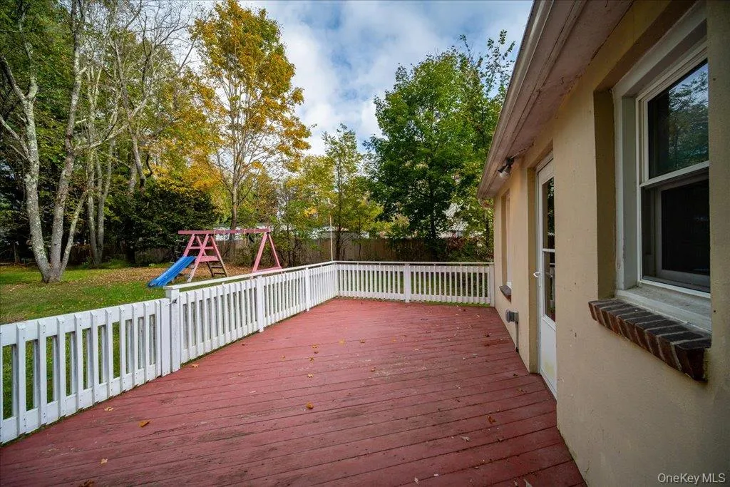 Wooden deck with a playground and a lawn Wooden deck with a playground and a lawn