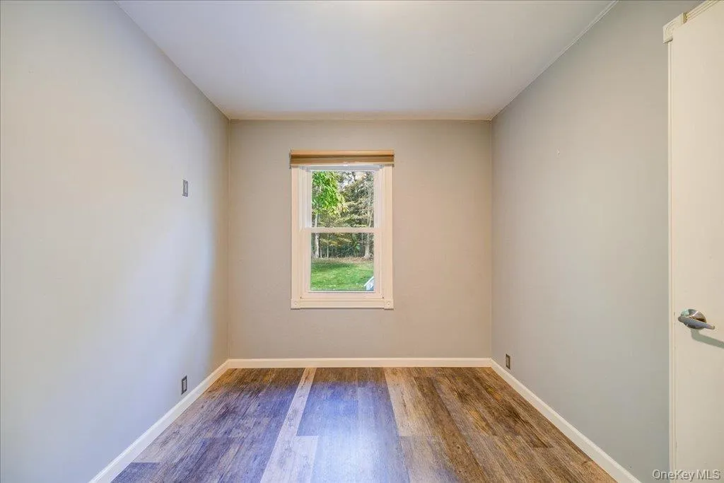 Unfurnished room with hardwood / wood-style floors Unfurnished room with hardwood / wood-style floors