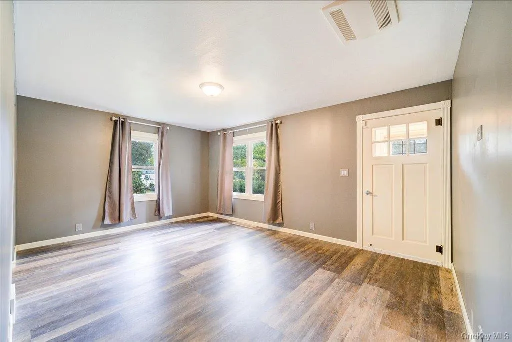 Foyer entrance featuring hardwood / wood-style floors Foyer entrance featuring hardwood / wood-style floors