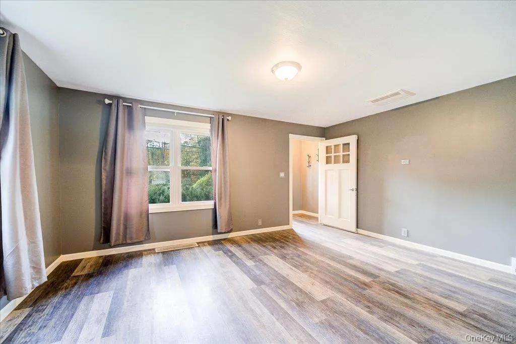 Living room featuring hardwood / wood-style flooring Living room featuring hardwood / wood-style flooring