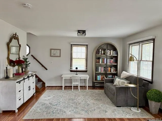 Sitting room with stairs and wood finished floors Sitting room with stairs and wood finished floors