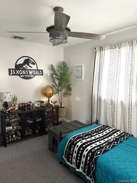 Bedroom featuring visible vents and carpet floors Bedroom featuring visible vents and carpet floors