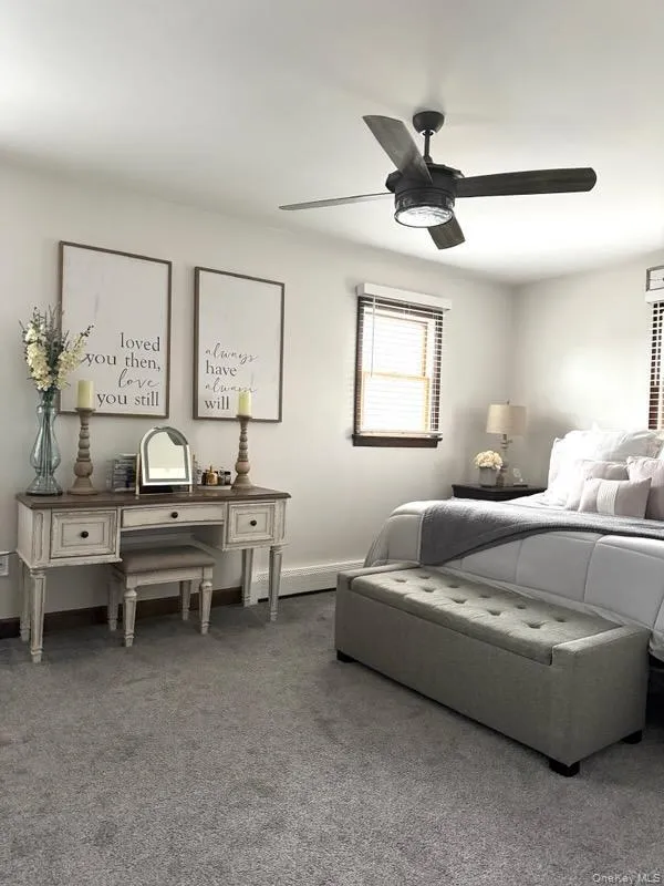 Bedroom with carpet flooring, a ceiling fan, and baseboards Bedroom with carpet flooring, a ceiling fan, and baseboards