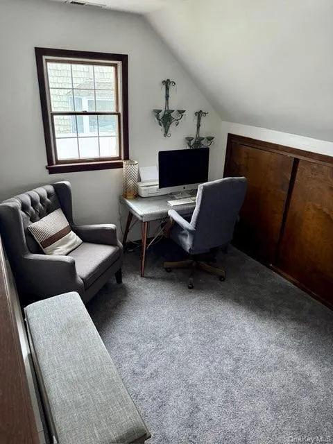 Office with lofted ceiling, visible vents, and carpet Office with lofted ceiling, visible vents, and carpet