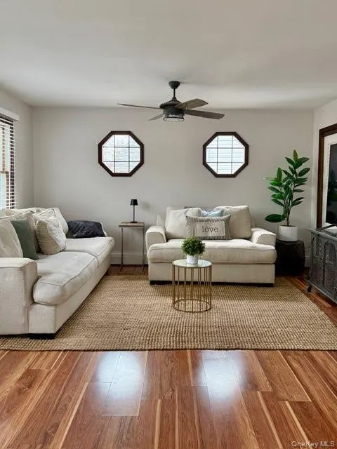 Living area with wood finished floors and ceiling fan Living area with wood finished floors and ceiling fan