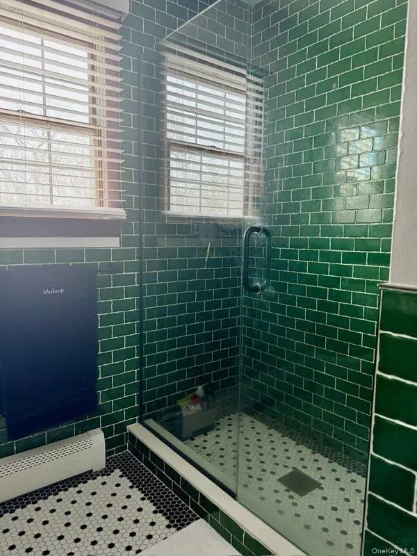 Full bath featuring a shower stall Full bath featuring a shower stall