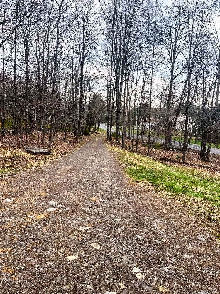 The property features a gravel pathway surrounded by mature trees The property features a gravel pathway surrounded by mature trees