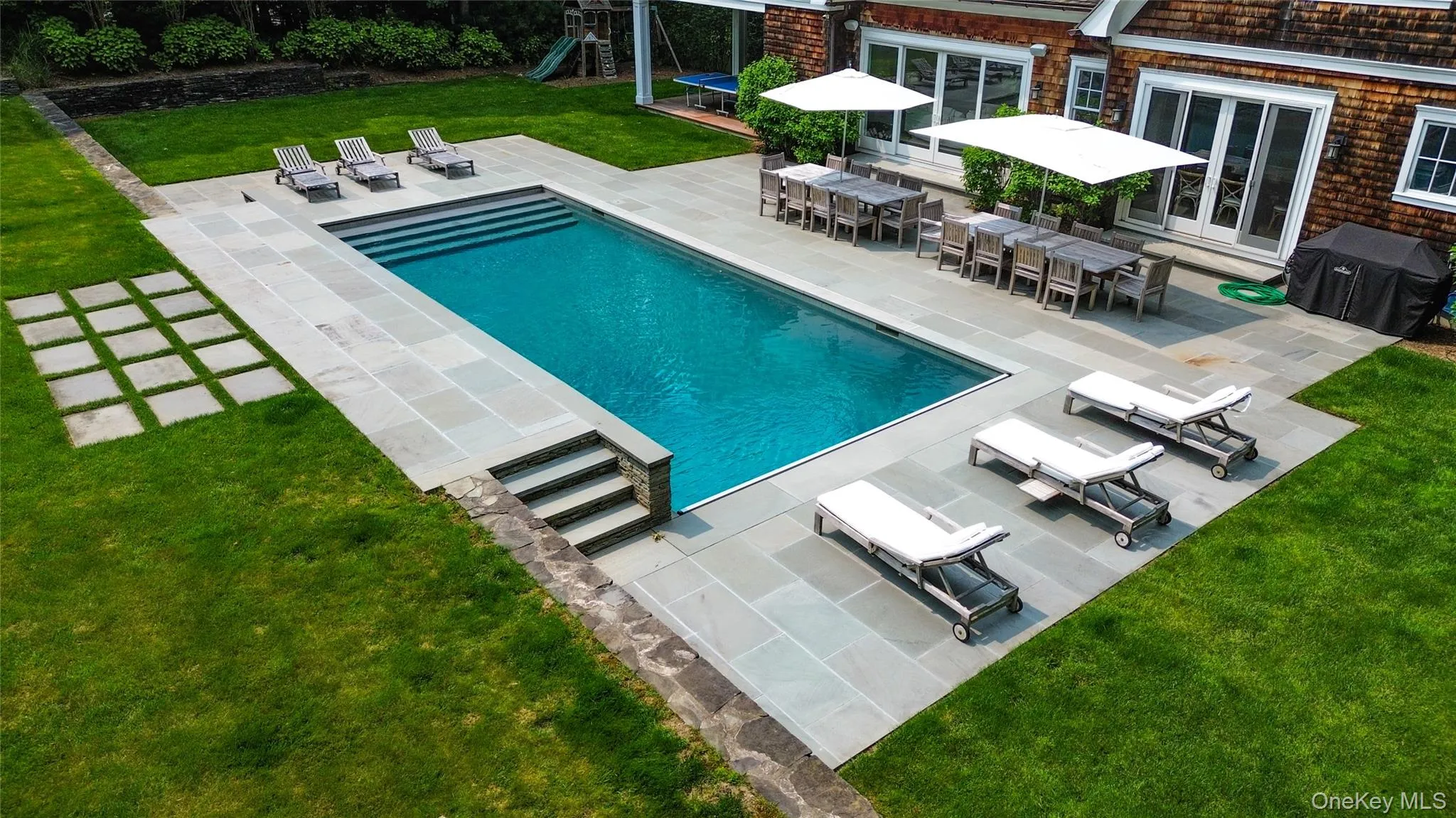 Expansive bluestone patio and resort style pool area Expansive bluestone patio and resort style pool area