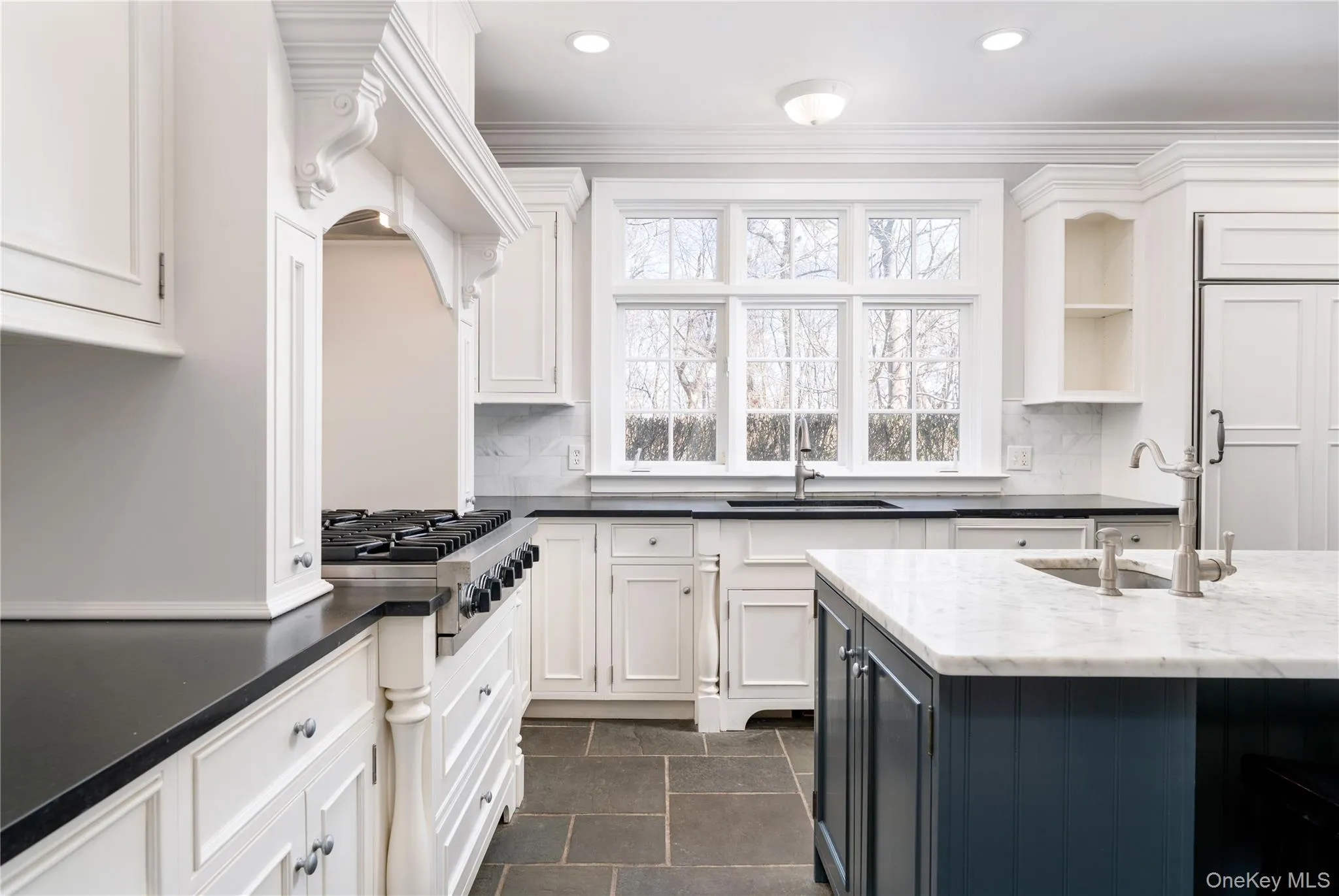 Chef's Kitchen With Custom Inset Cabinetry, Leathered Granite Counters, Marble Backsplash, Viking Professional Appliances, Center Island With Carrara Marble Counters, Radiant Heated Floors, And Breakfast Area Surrounded By Windows. Chef's Kitchen With Custom Inset Cabinetry, Leathered Granite Counters, Marble Backsplash, Viking Professional Appliances, Center Island With Carrara Marble Counters, Radiant Heated Floors, And Breakfast Area Surrounded By Windows.