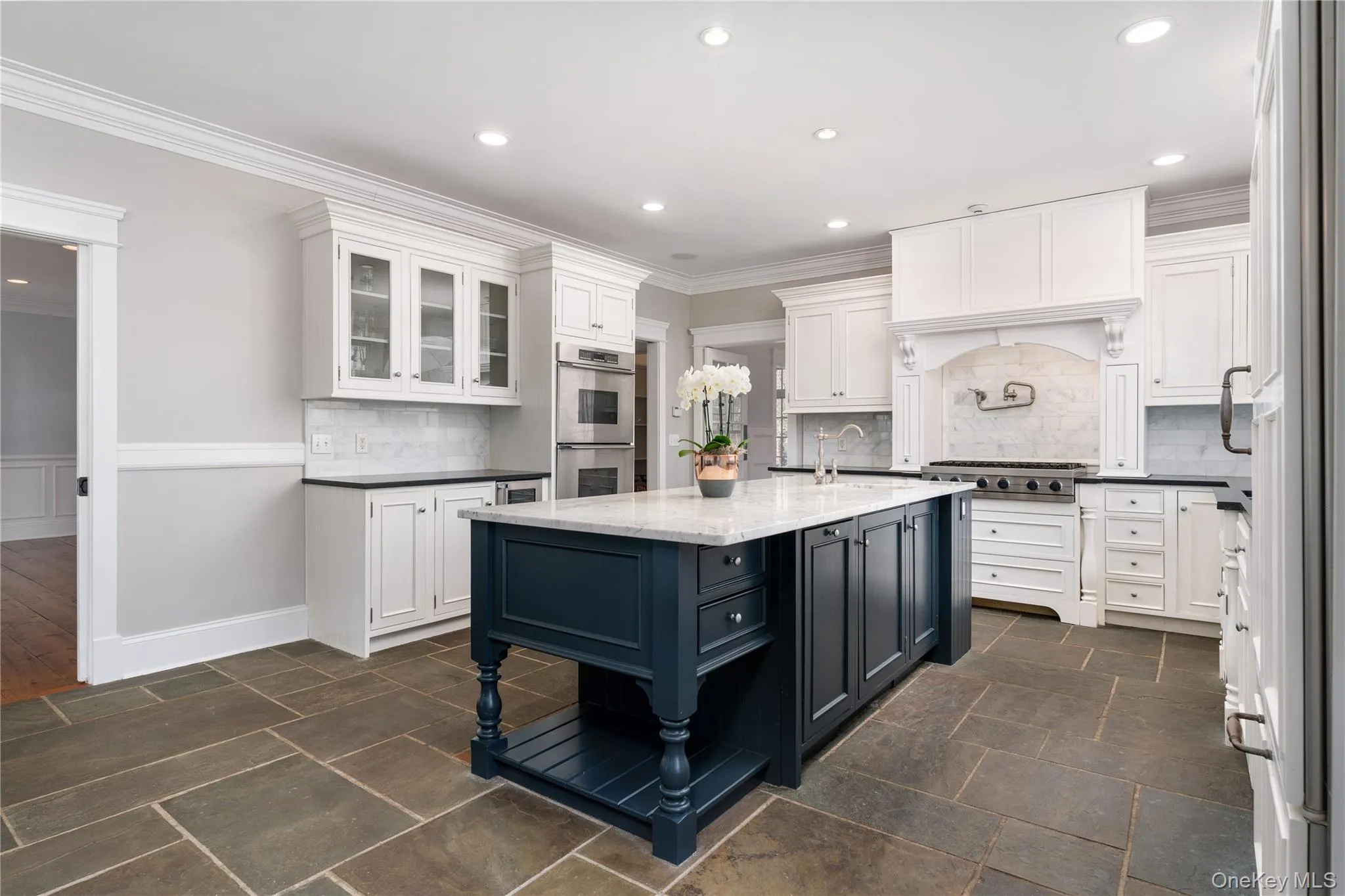 Chef's Kitchen With Custom Inset Cabinetry, Leathered Granite Counters, Marble Backsplash, Viking Professional Appliances, Center Island With Carrara Marble Counters, Radiant Heated Floors, And Breakfast Area Surrounded By Windows. Chef's Kitchen With Custom Inset Cabinetry, Leathered Granite Counters, Marble Backsplash, Viking Professional Appliances, Center Island With Carrara Marble Counters, Radiant Heated Floors, And Breakfast Area Surrounded By Windows.