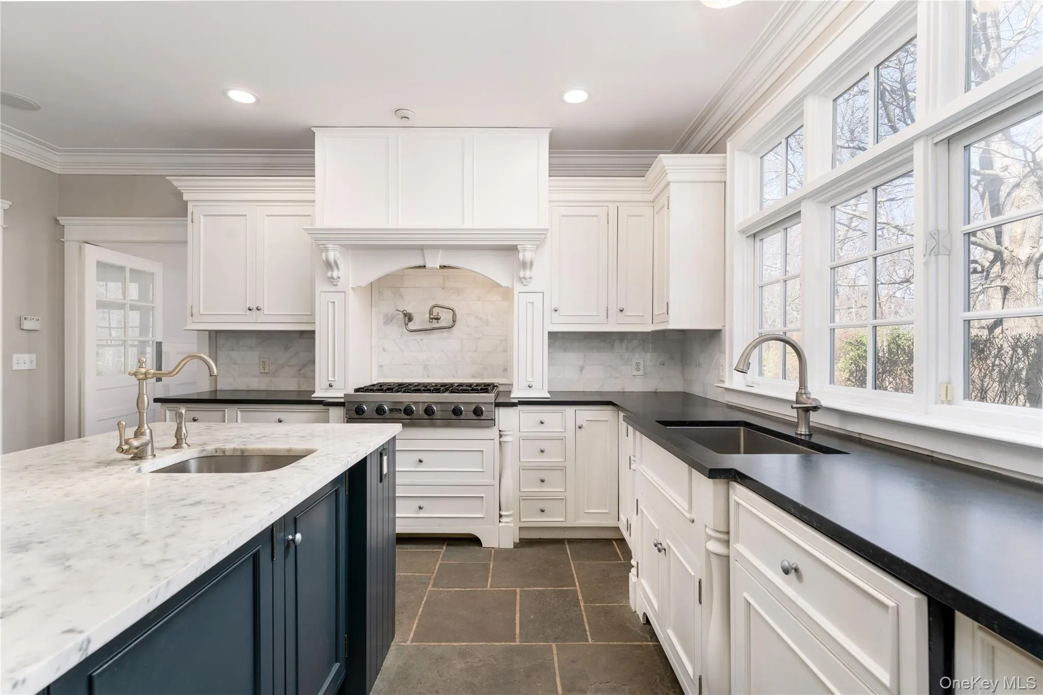 Chef's Kitchen With Custom Inset Cabinetry, Leathered Granite Counters, Marble Backsplash, Viking Professional Appliances, Center Island With Carrara Marble Counters, Radiant Heated Floors, And Breakfast Area Surrounded By Windows. Chef's Kitchen With Custom Inset Cabinetry, Leathered Granite Counters, Marble Backsplash, Viking Professional Appliances, Center Island With Carrara Marble Counters, Radiant Heated Floors, And Breakfast Area Surrounded By Windows.