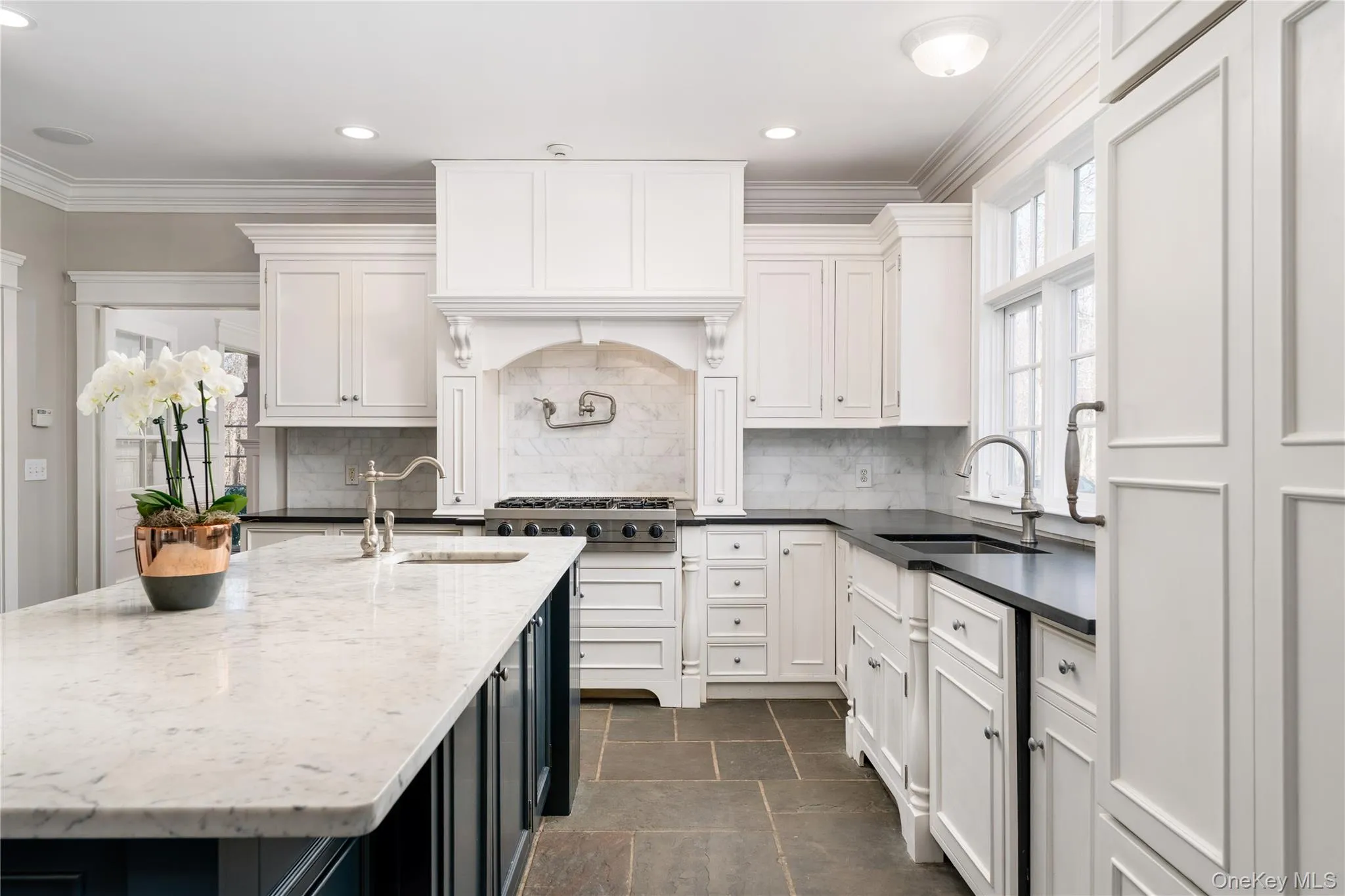 Chef's Kitchen With Custom Inset Cabinetry, Leathered Granite Counters, Marble Backsplash, Viking Professional Appliances, Center Island With Carrara Marble Counters, Radiant Heated Floors, And Breakfast Area Surrounded By Windows. Chef's Kitchen With Custom Inset Cabinetry, Leathered Granite Counters, Marble Backsplash, Viking Professional Appliances, Center Island With Carrara Marble Counters, Radiant Heated Floors, And Breakfast Area Surrounded By Windows.