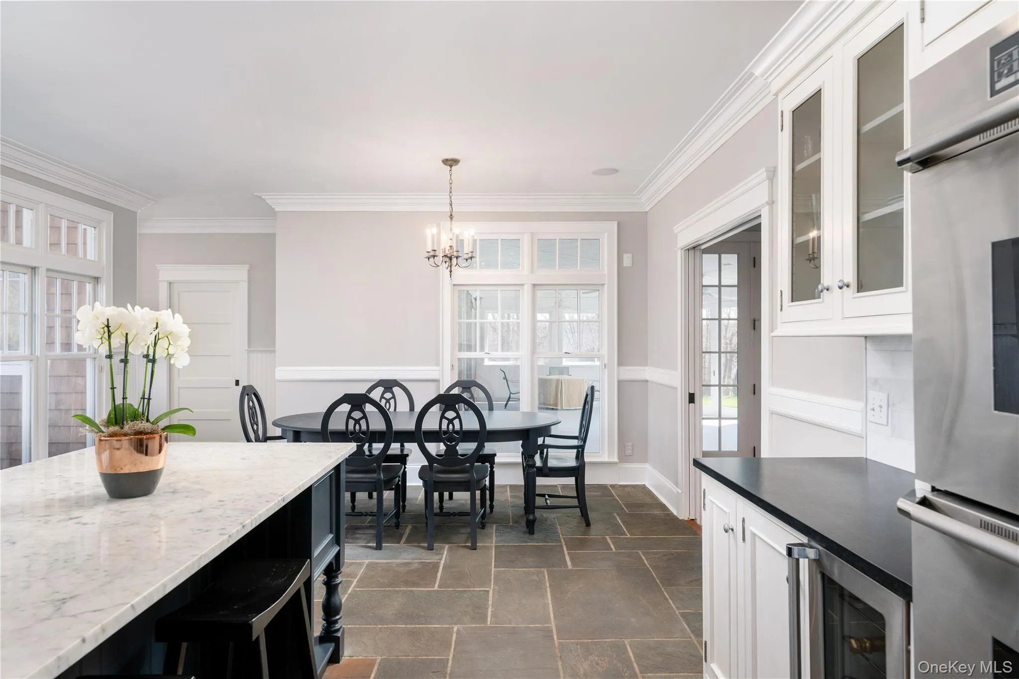 Chef's Kitchen With Custom Inset Cabinetry, Leathered Granite Counters, Marble Backsplash, Viking Professional Appliances, Center Island With Carrara Marble Counters, Radiant Heated Floors, And Breakfast Area Surrounded By Windows. Chef's Kitchen With Custom Inset Cabinetry, Leathered Granite Counters, Marble Backsplash, Viking Professional Appliances, Center Island With Carrara Marble Counters, Radiant Heated Floors, And Breakfast Area Surrounded By Windows.