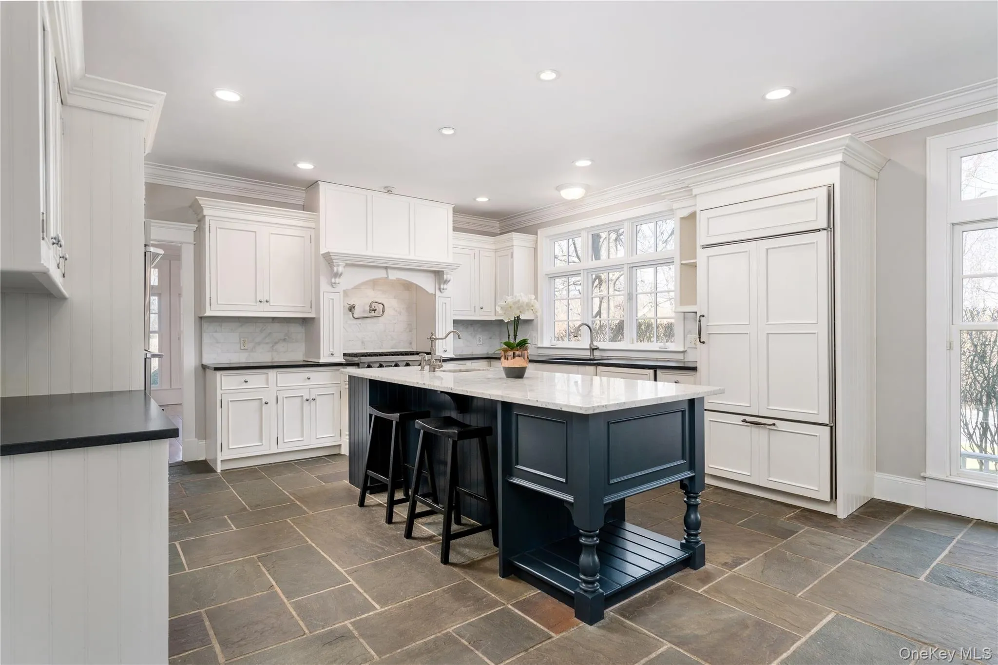 Chef's Kitchen With Custom Inset Cabinetry, Leathered Granite Counters, Marble Backsplash, Viking Professional Appliances, Center Island With Carrara Marble Counters, Radiant Heated Floors, And Breakfast Area Surrounded By Windows. Chef's Kitchen With Custom Inset Cabinetry, Leathered Granite Counters, Marble Backsplash, Viking Professional Appliances, Center Island With Carrara Marble Counters, Radiant Heated Floors, And Breakfast Area Surrounded By Windows.