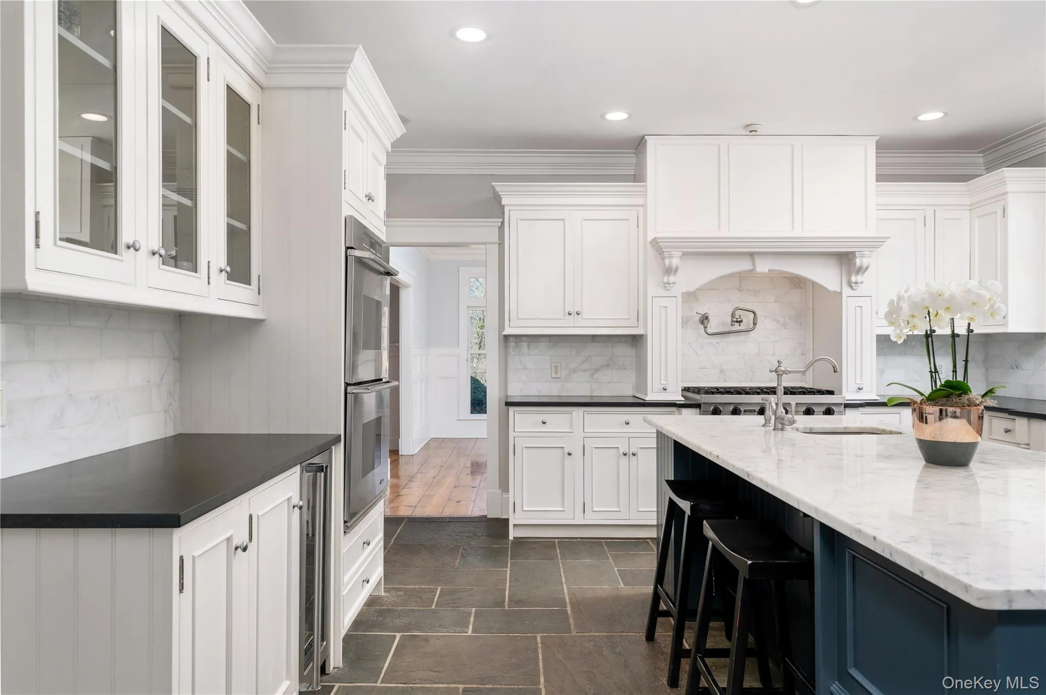 Chef's Kitchen With Custom Inset Cabinetry, Leathered Granite Counters, Marble Backsplash, Viking Professional Appliances, Center Island With Carrara Marble Counters, Radiant Heated Floors, And Breakfast Area Surrounded By Windows. Chef's Kitchen With Custom Inset Cabinetry, Leathered Granite Counters, Marble Backsplash, Viking Professional Appliances, Center Island With Carrara Marble Counters, Radiant Heated Floors, And Breakfast Area Surrounded By Windows.