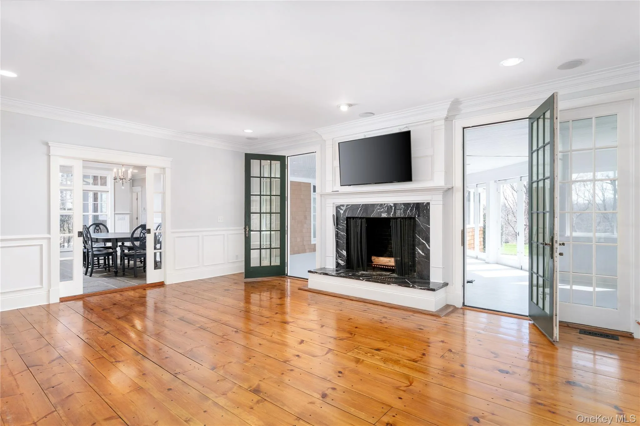 Generously Proportioned Den With Wood Burning Fireplace With Pocket Doors To Kitchen and French Doors To Sunroom and Enclosed Porch. Generously Proportioned Den With Wood Burning Fireplace With Pocket Doors To Kitchen and French Doors To Sunroom and Enclosed Porch.