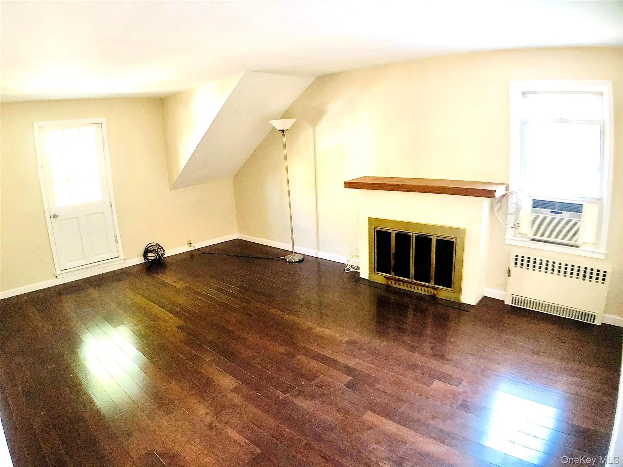 Large living room with hardwood flooring throughout apartment. Large living room with hardwood flooring throughout apartment.