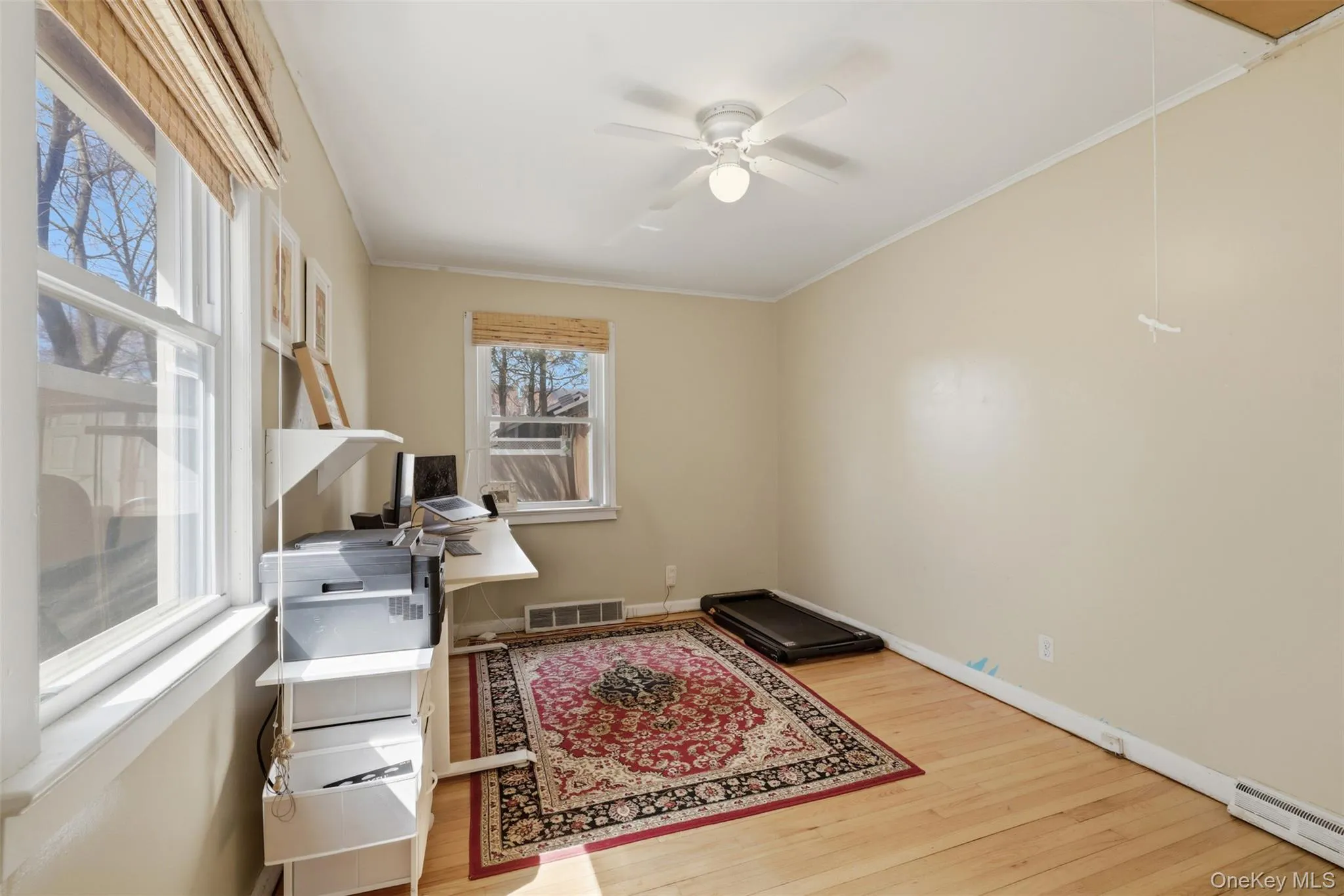 Bedroom currently setup as an office with hardwood floors, and lots of natural light Bedroom currently setup as an office with hardwood floors, and lots of natural light