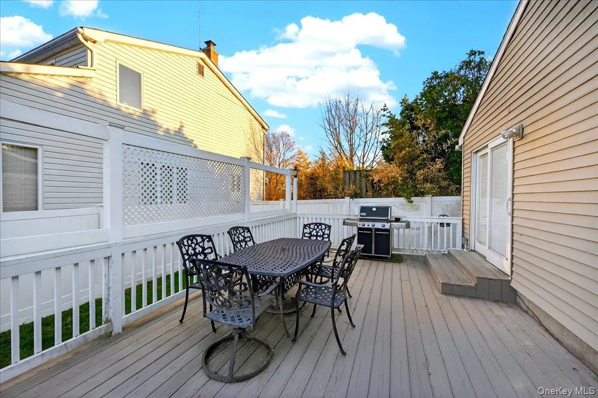 Wooden terrace with area for grilling and outdoor dining area Wooden terrace with area for grilling and outdoor dining area