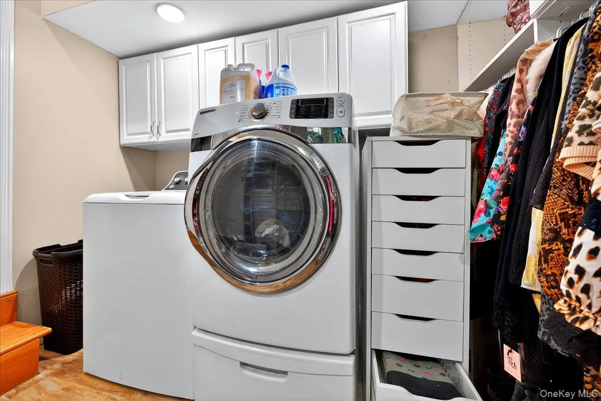 Laundry area with independent washer and dryer and cabinet space Laundry area with independent washer and dryer and cabinet space