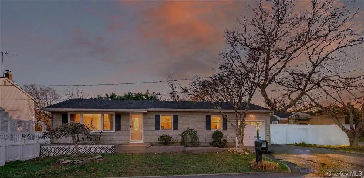 Ranch-style house with a garage and driveway Ranch-style house with a garage and driveway