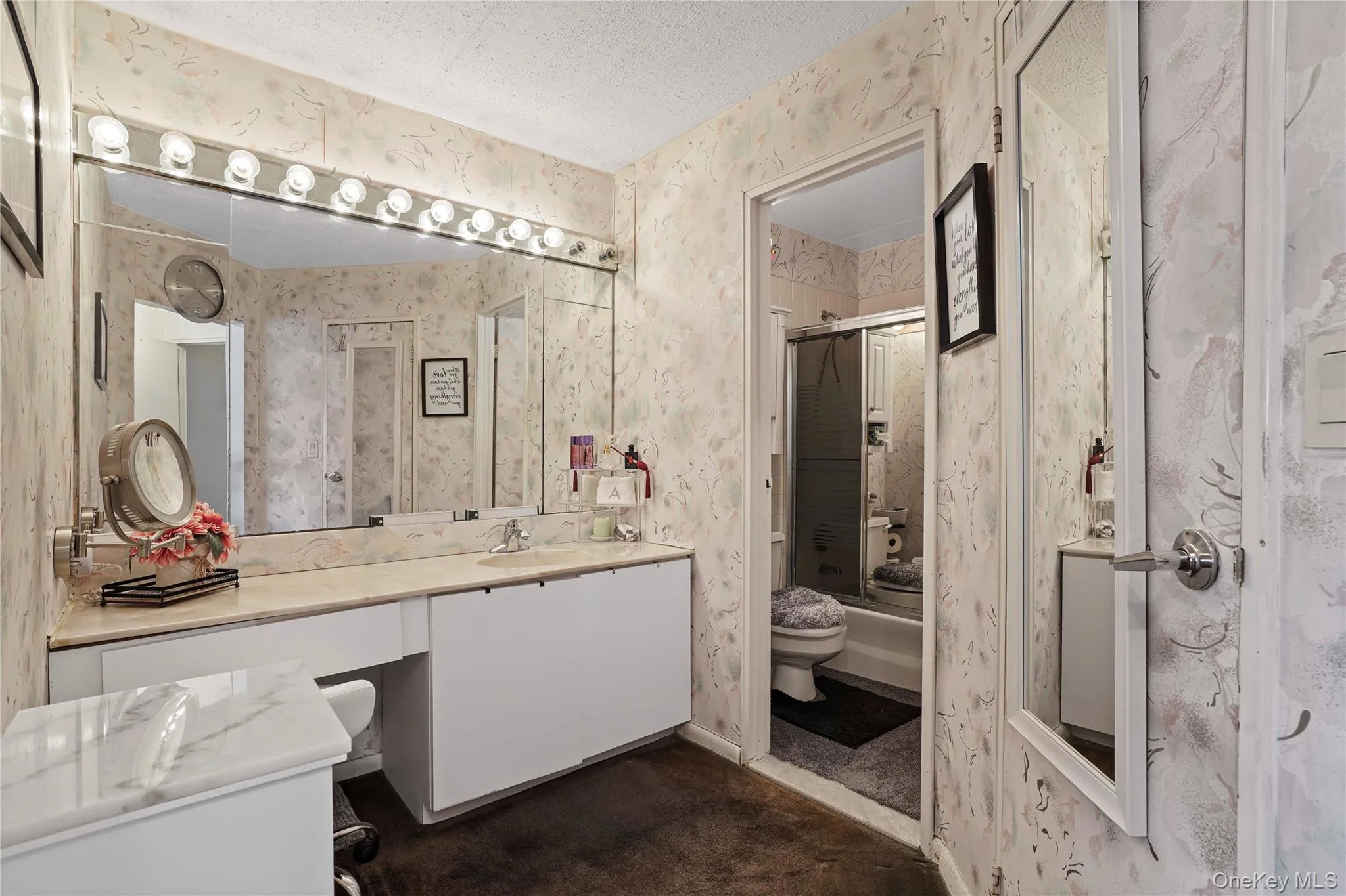 Primary bathroom with vanity sink and toilet. A very large walk-in closet finishes the room. Primary bathroom with vanity sink and toilet. A very large walk-in closet finishes the room.