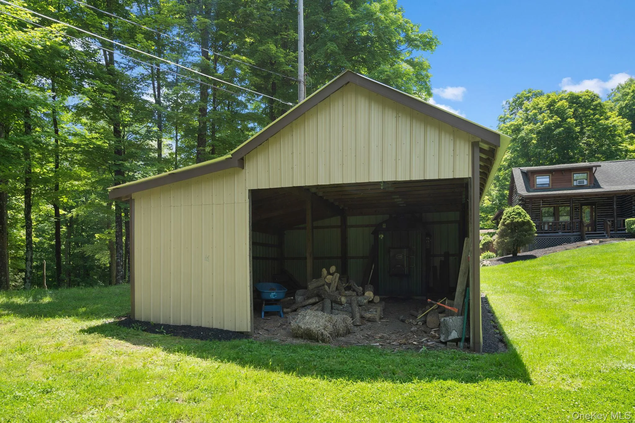 View of pole building featuring a yard View of pole building featuring a yard