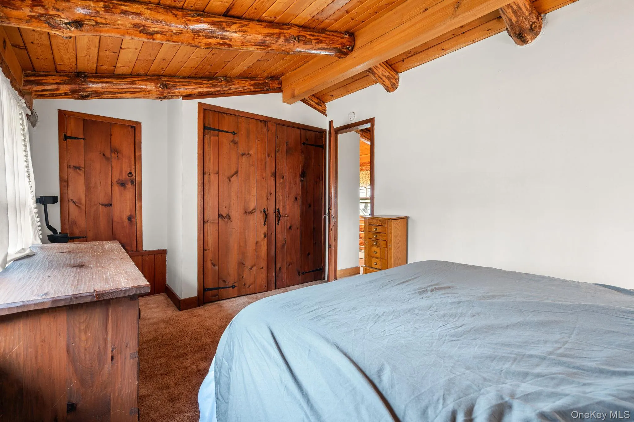 Bedroom with carpet floors and wood ceiling Bedroom with carpet floors and wood ceiling